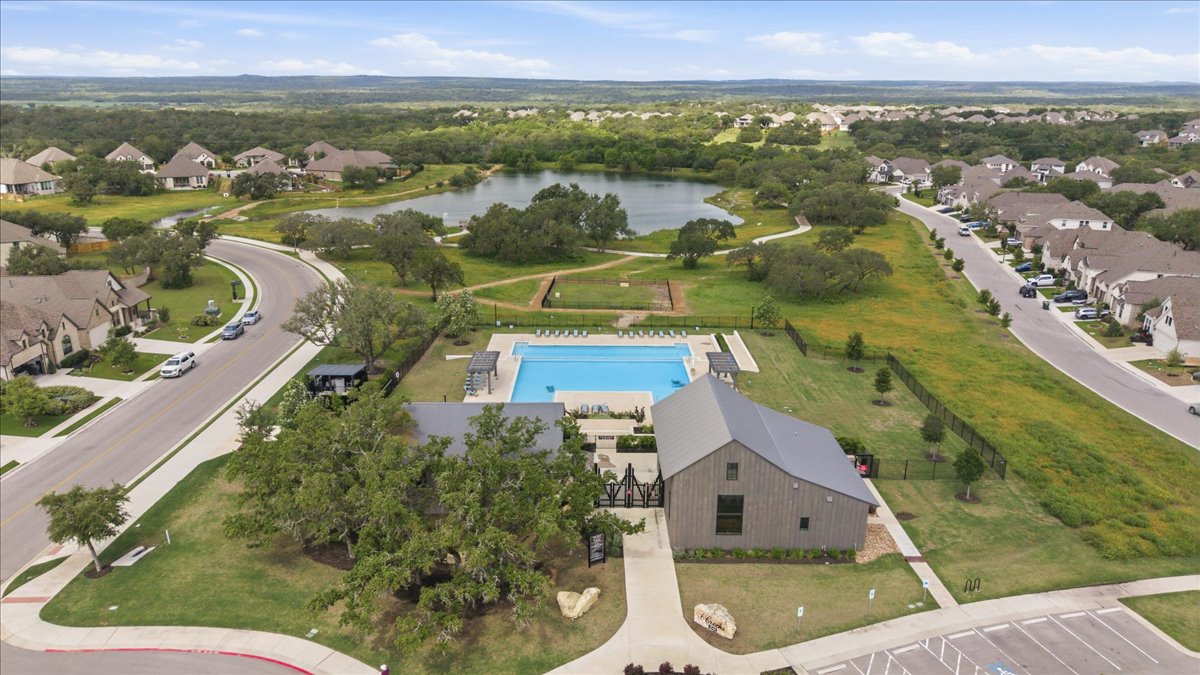 366 Cold Riv Run Kyle, TX 78640 - Photo 28 of 31 Community amenities featuring a large swimming pool, club house, and a fishing pond