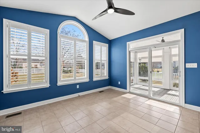 a view of empty room with wooden floor and window
