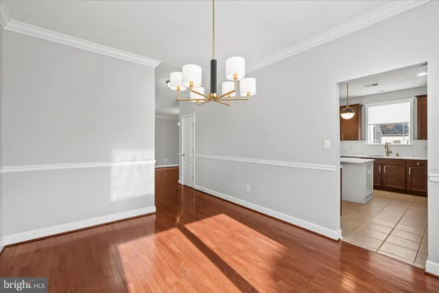 a bedroom with a bed a couch and a chandelier