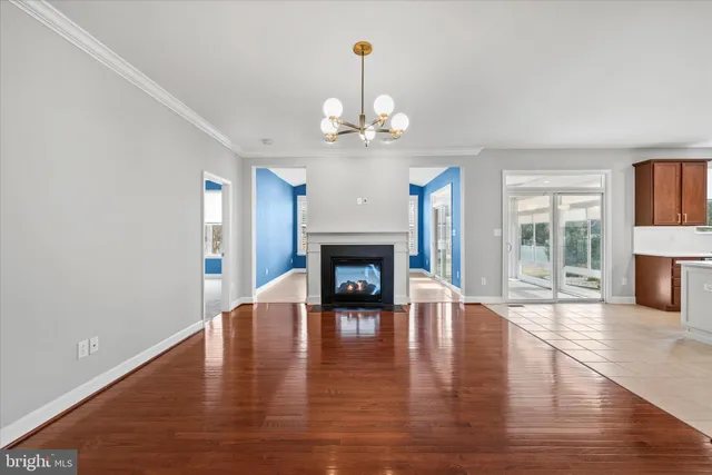 a view of a room with wooden floor fireplace and a window