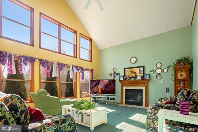 a living room with furniture a fireplace and a window
