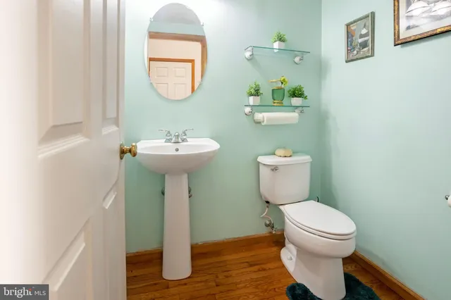 a bathroom with a toilet a sink and a mirror