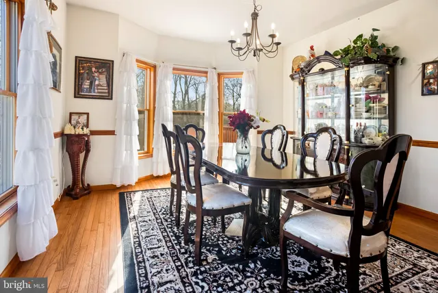 a view of a dining room with furniture and a chandelier