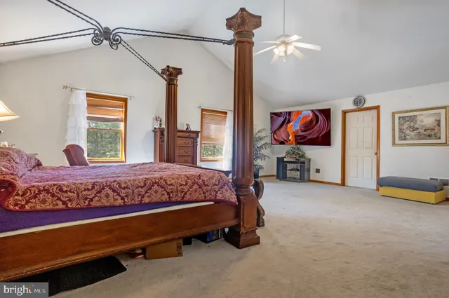 a bed room with a bed and a chair