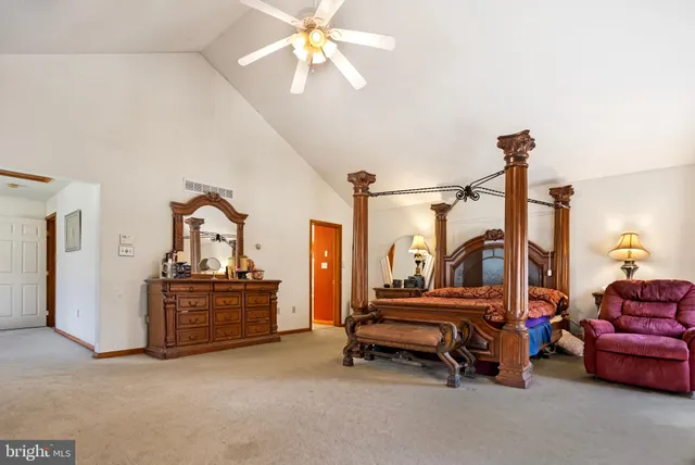 a bedroom with furniture and a chandelier