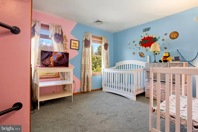 a bedroom with furniture and baby crib