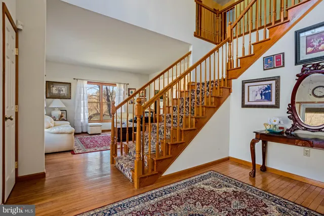 a living room with wooden floor and stairs