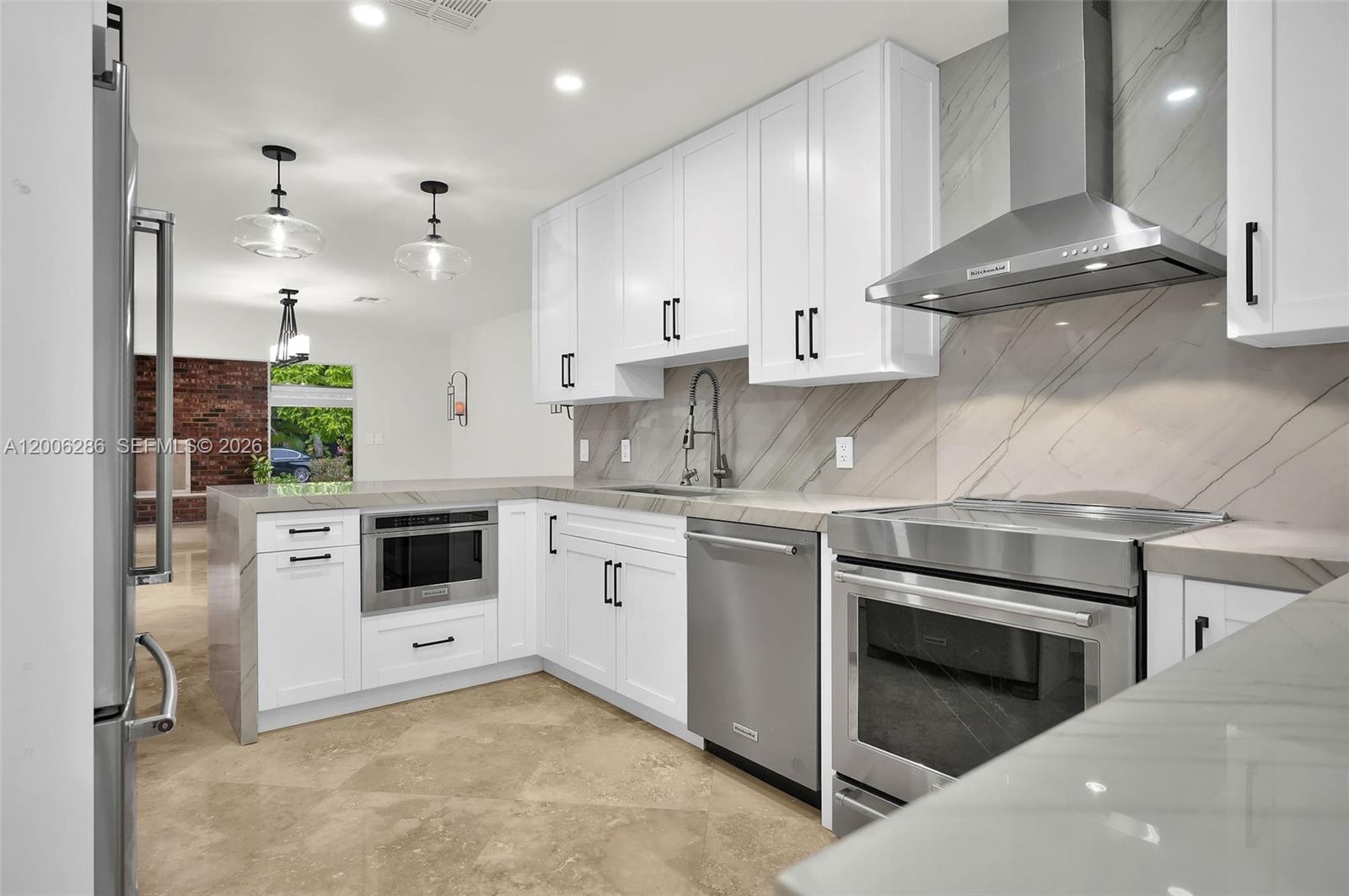 6820 Southwest 86th Avenue Miami, FL 33143 - Photo 12 of 37 a kitchen with stainless steel appliances granite countertop a stove a sink and a refrigerator