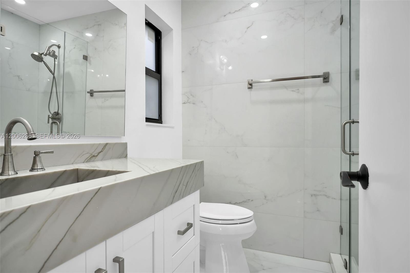 6820 Southwest 86th Avenue Miami, FL 33143 - Photo 14 of 37 a bathroom with a toilet sink and shower