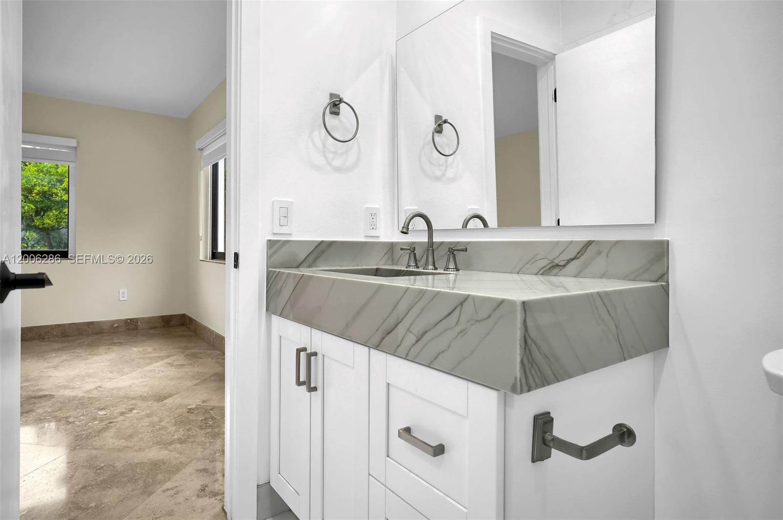 6820 Southwest 86th Avenue Miami, FL 33143 - Photo 15 of 37 a bathroom with a sink and a mirror