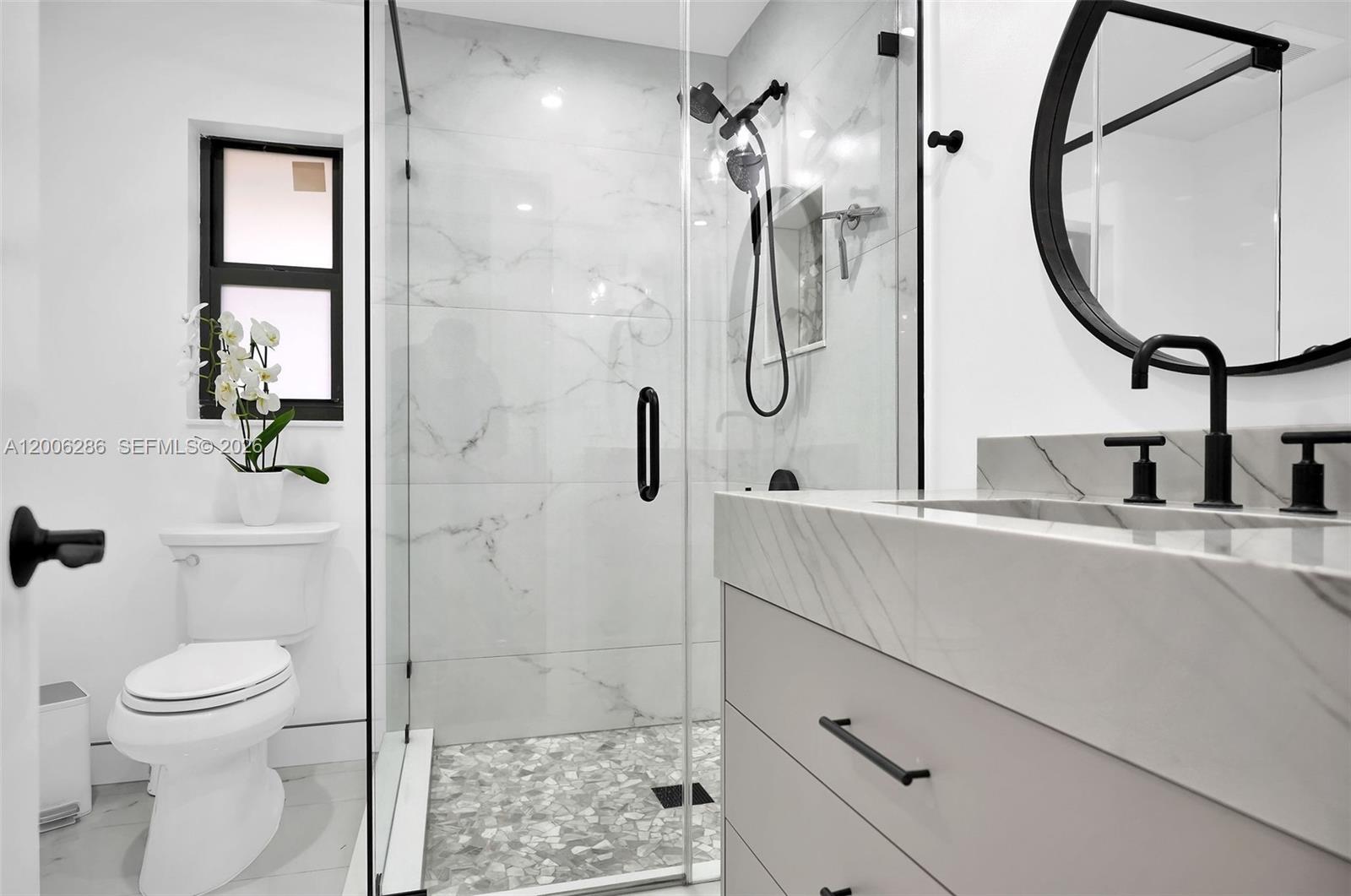 6820 Southwest 86th Avenue Miami, FL 33143 - Photo 18 of 37 a bathroom with a sink a toilet and shower
