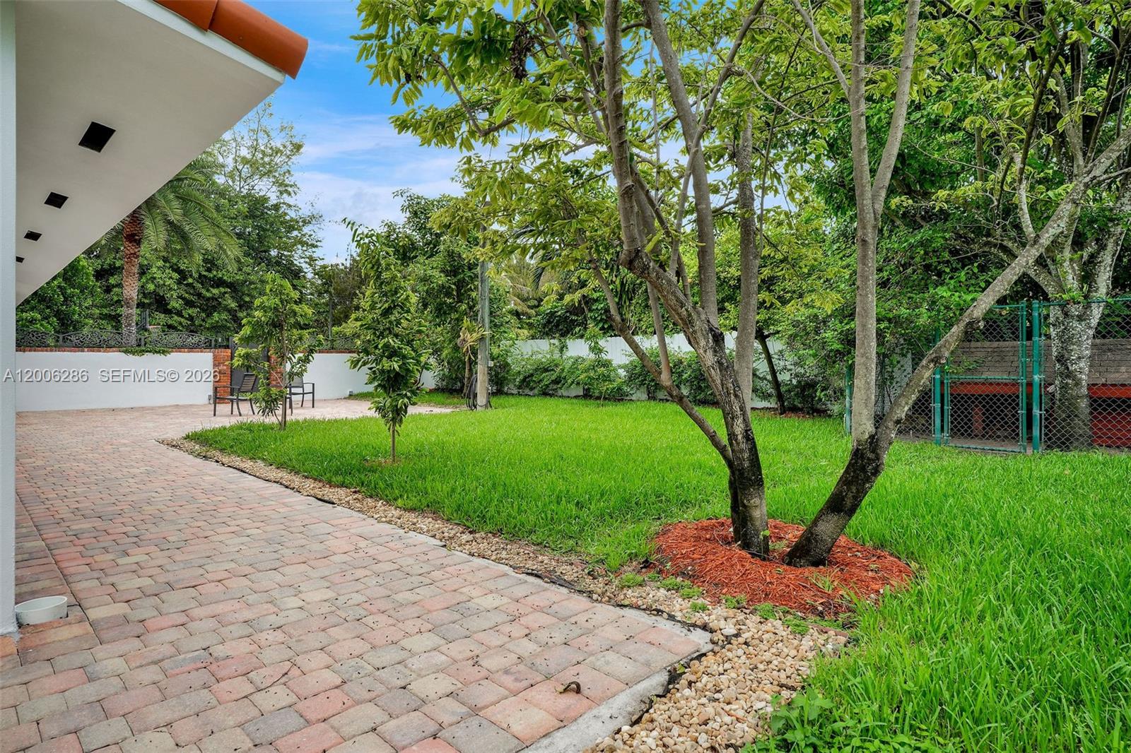 6820 Southwest 86th Avenue Miami, FL 33143 - Photo 25 of 37 a view of a garden with a fountain