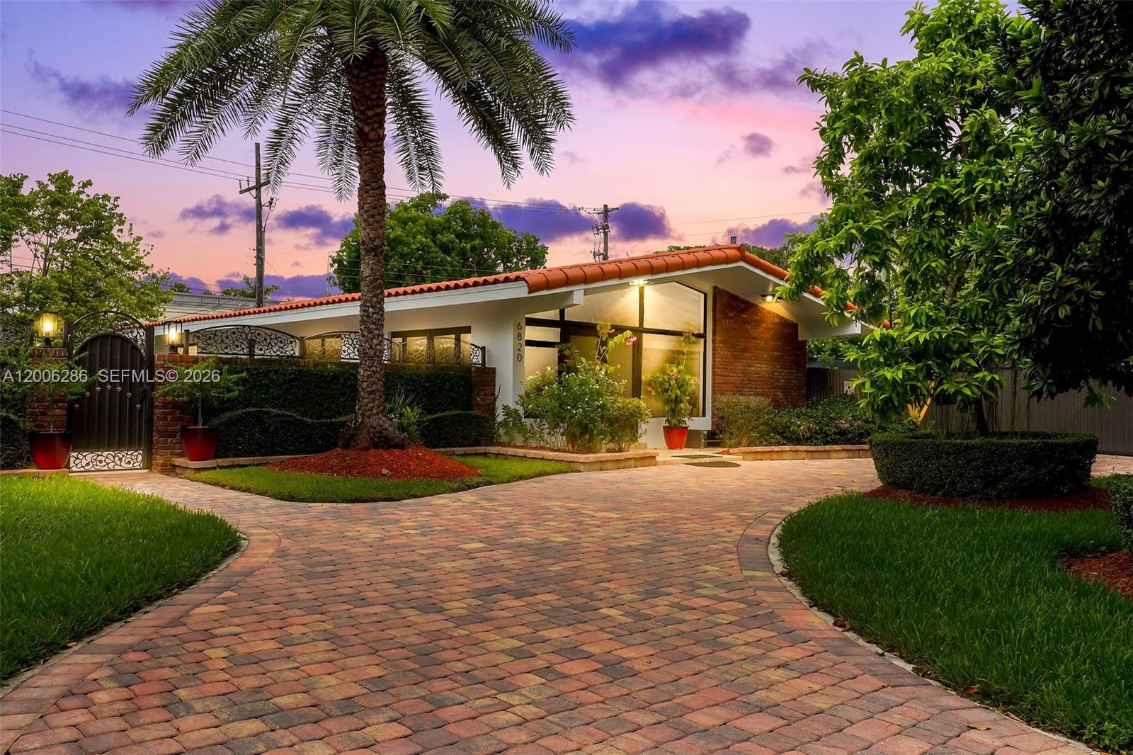 6820 Southwest 86th Avenue Miami, FL 33143 - Photo 27 of 37 a view of a house with a yard and a garden
