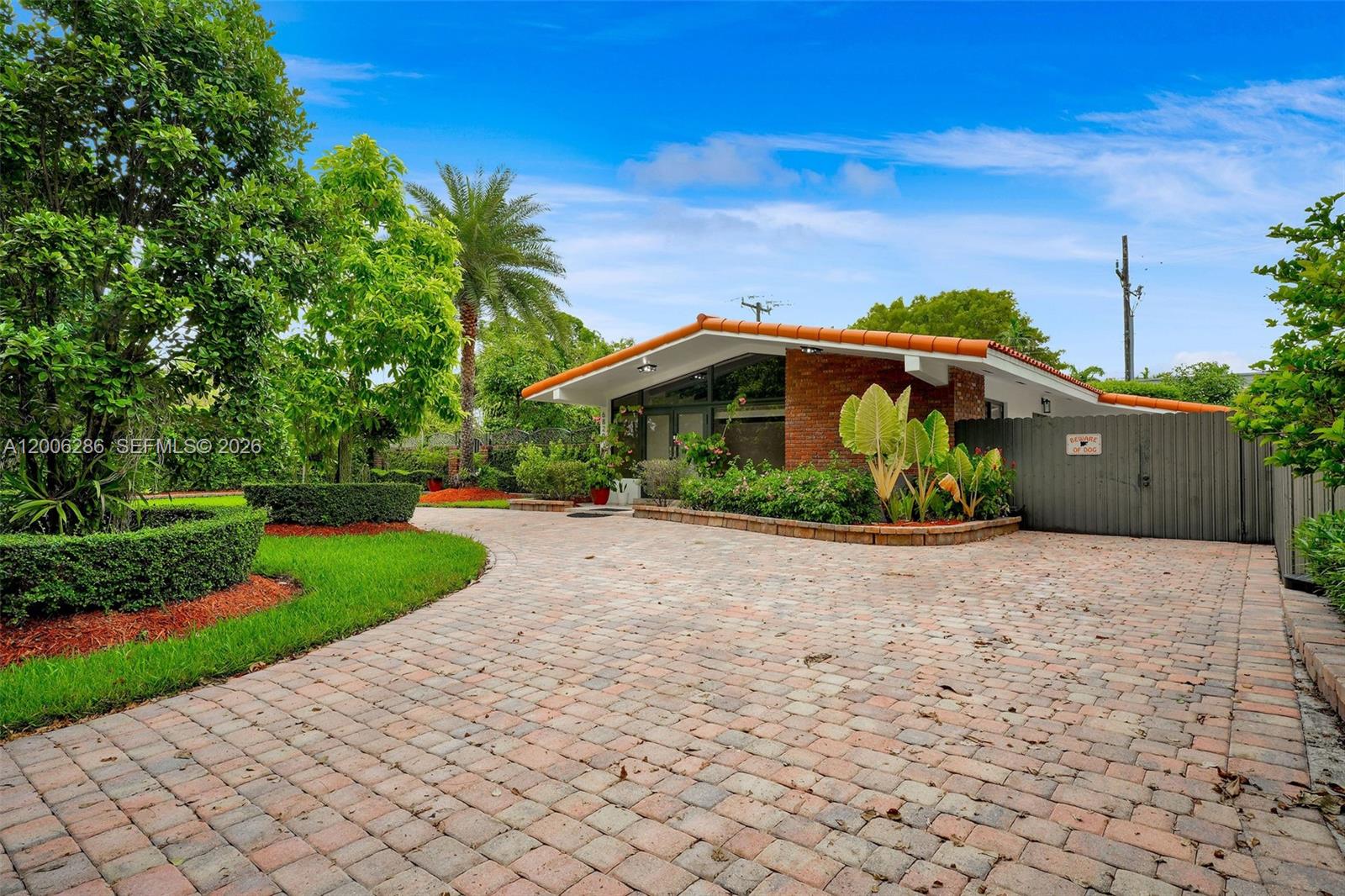 6820 Southwest 86th Avenue Miami, FL 33143 - Photo 28 of 37 a front view of a house with a yard and garage