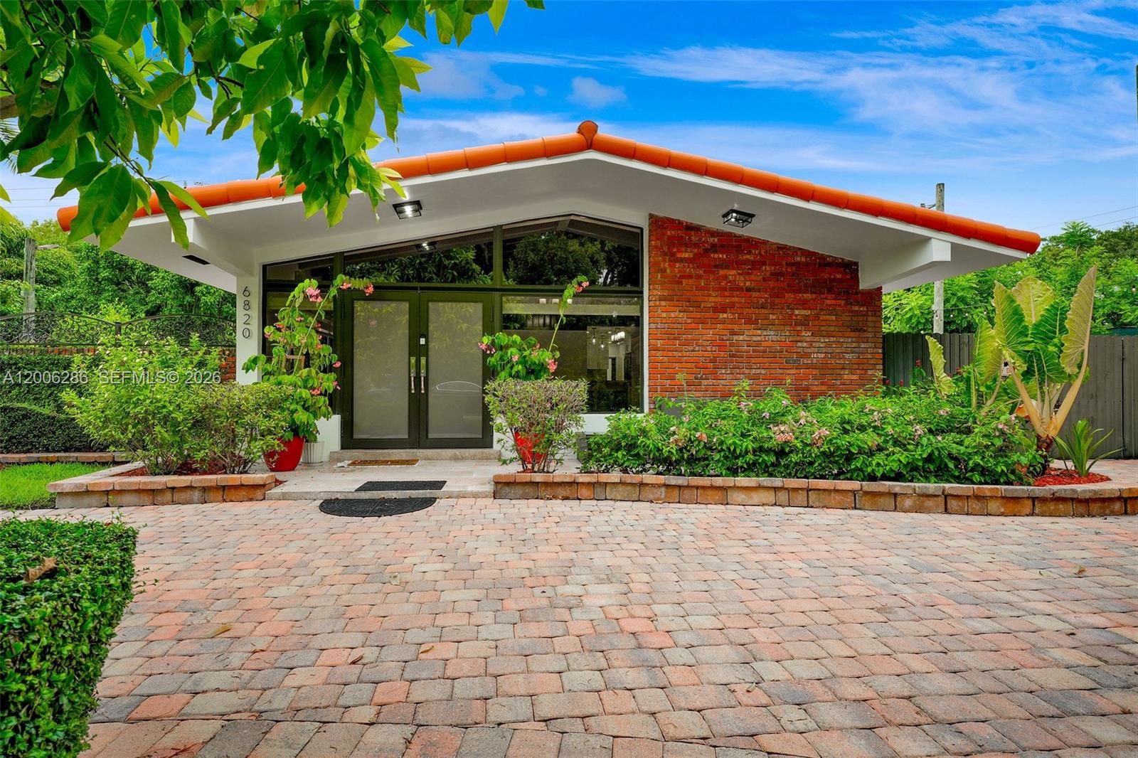 6820 Southwest 86th Avenue Miami, FL 33143 - Photo 29 of 37 a front view of a building with garden