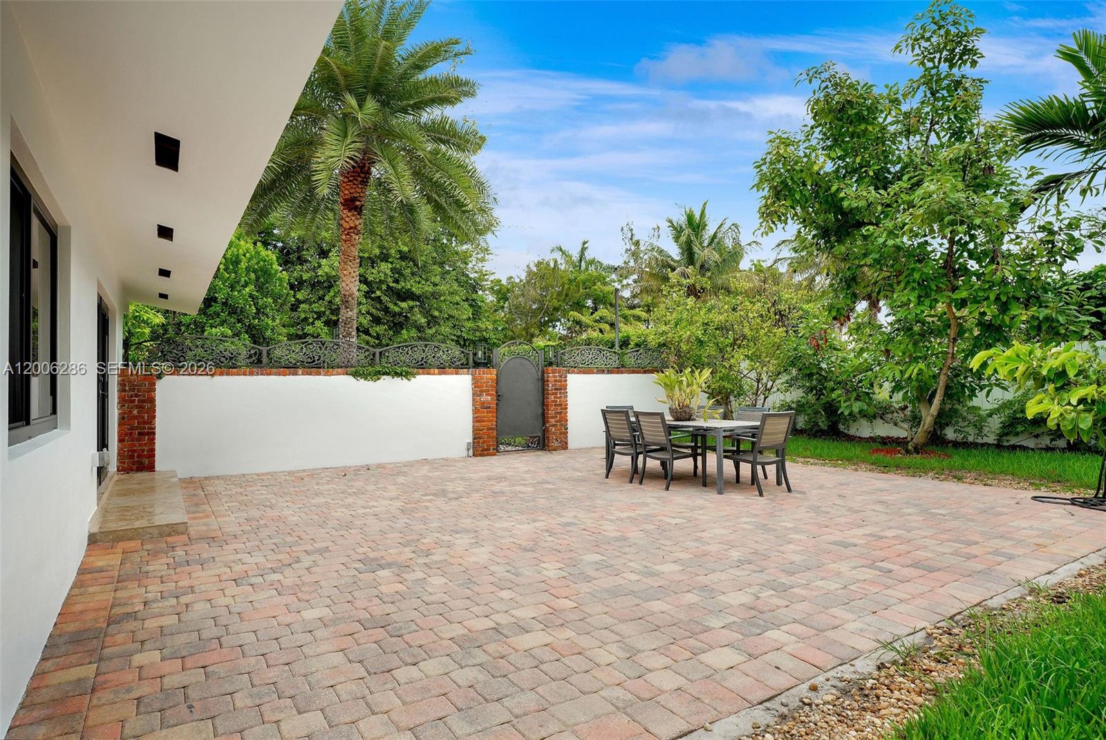 6820 Southwest 86th Avenue Miami, FL 33143 - Photo 32 of 37 a view of backyard with a table and chairs