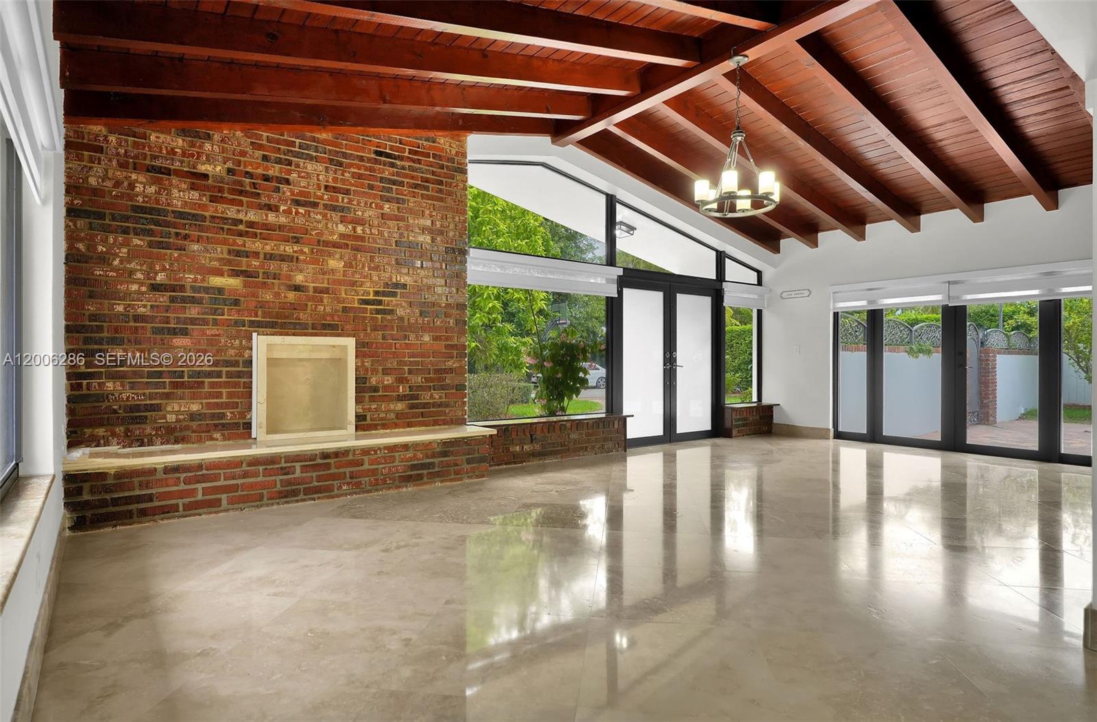 6820 Southwest 86th Avenue Miami, FL 33143 - Photo 4 of 37 a view of an empty room with wooden floor and a window