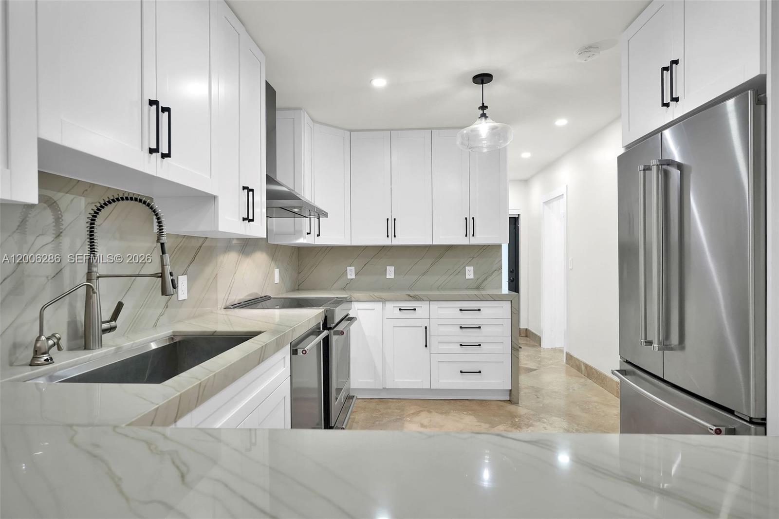 6820 Southwest 86th Avenue Miami, FL 33143 - Photo 10 of 37 a kitchen with granite countertop a sink stainless steel appliances and cabinets
