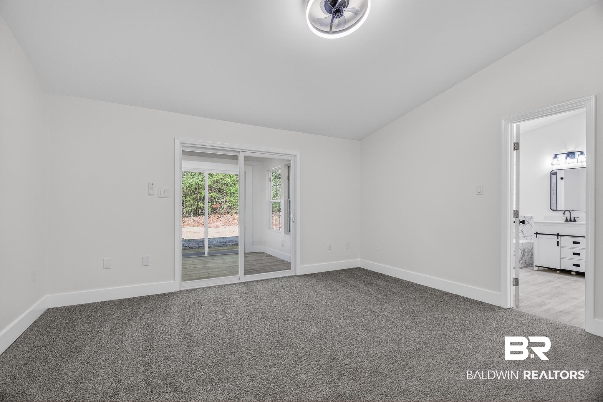 10650 Old Pascagoula Road Theodore, AL 36582 - Photo 61 of 77 Empty room featuring lofted ceiling and carpet flooring