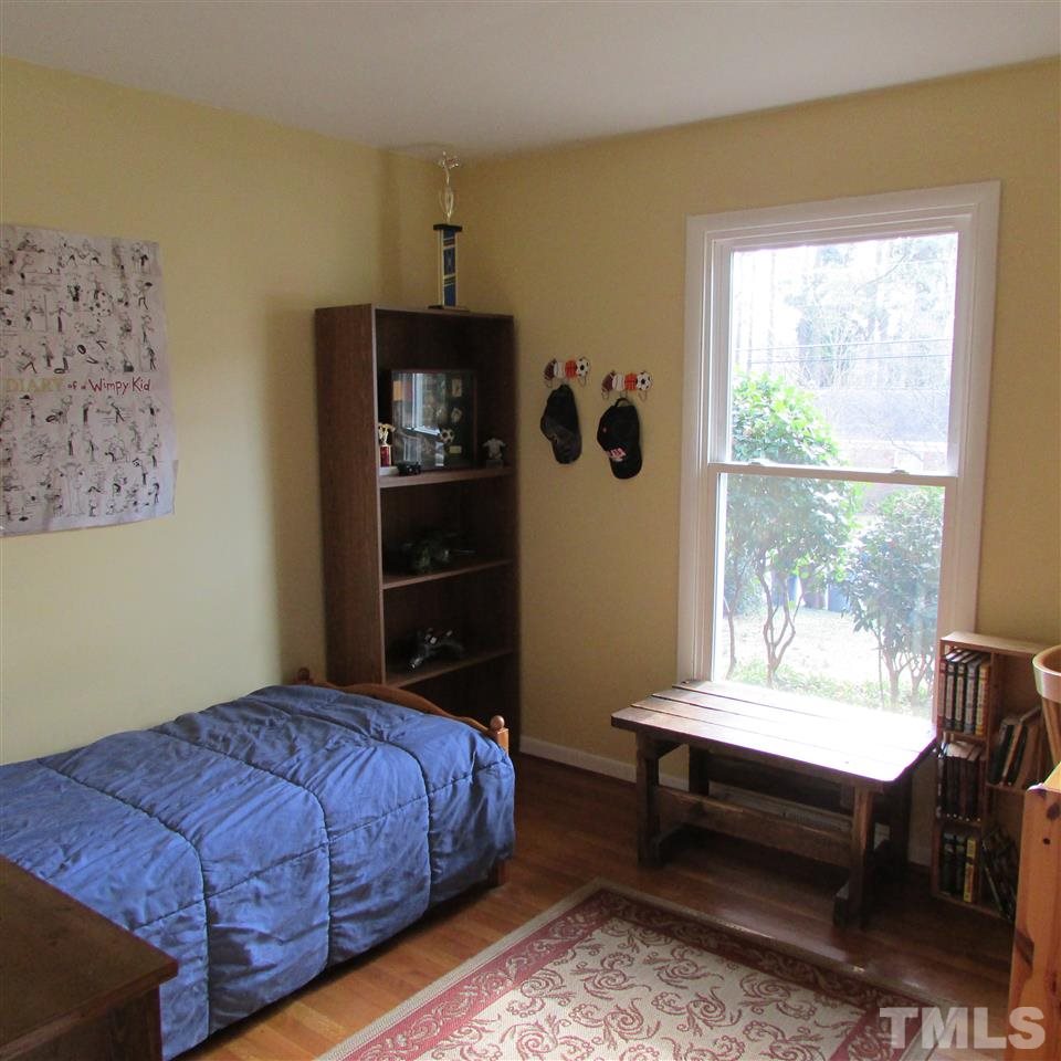 609 Duke Drive Raleigh, NC 27609 - Photo 14 of 22 a bedroom with a bed and a window