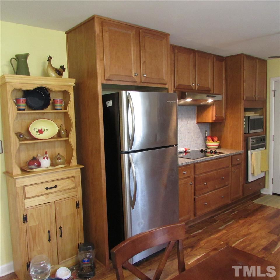 609 Duke Drive Raleigh, NC 27609 - Photo 3 of 22 a kitchen with a refrigerator and cabinets