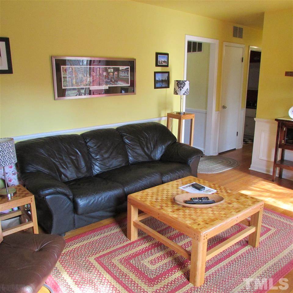 609 Duke Drive Raleigh, NC 27609 - Photo 8 of 22 a living room with furniture and a table