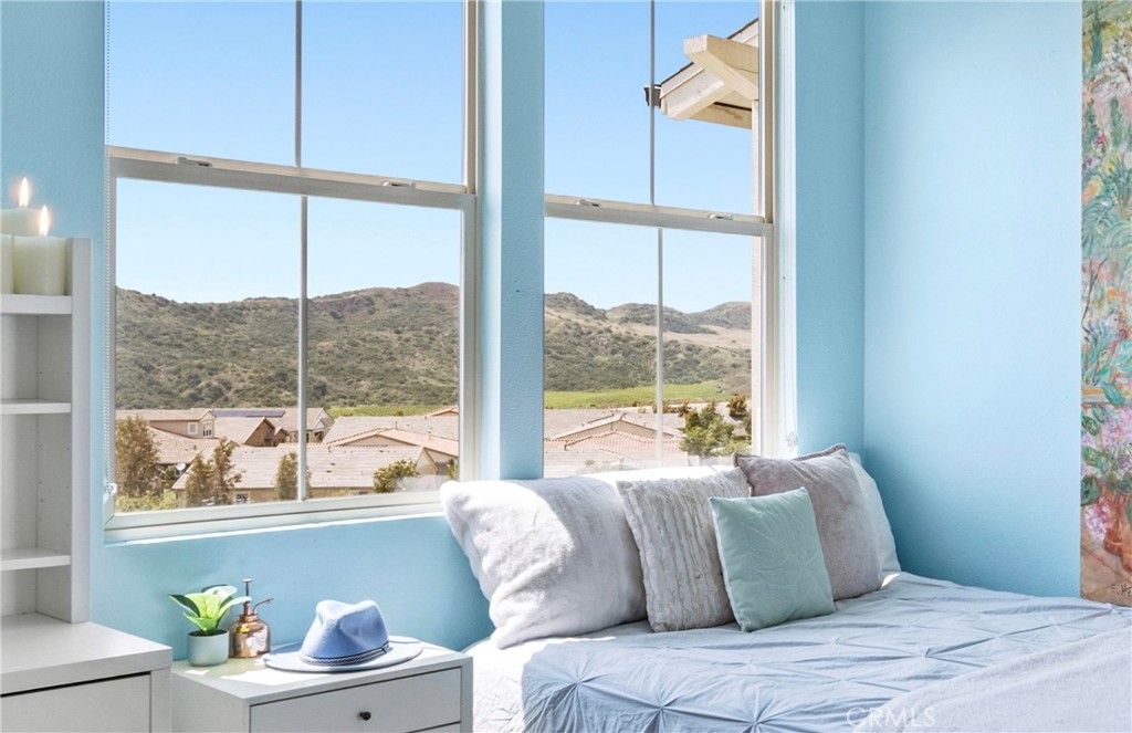 75 Promesa Avenue Rancho Mission Viejo, CA 92694 - Photo 37 of 47 a bedroom with a large window and a bed