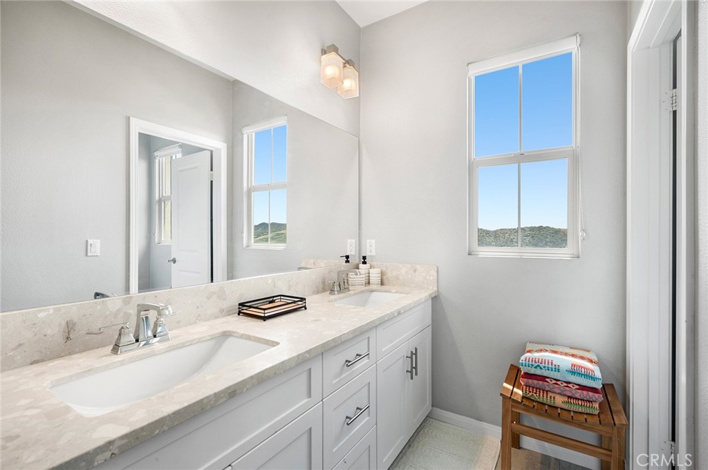 75 Promesa Avenue Rancho Mission Viejo, CA 92694 - Photo 38 of 47 a bathroom with a granite countertop sink and a mirror