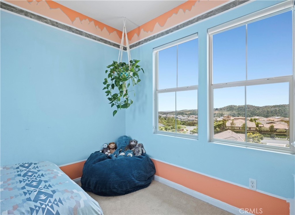 75 Promesa Avenue Rancho Mission Viejo, CA 92694 - Photo 39 of 47 a bedroom with a bed and a potted plant