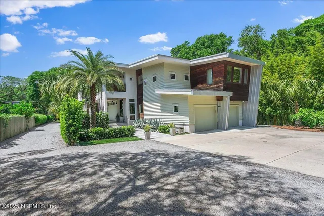 a front view of a house with a garden and yard