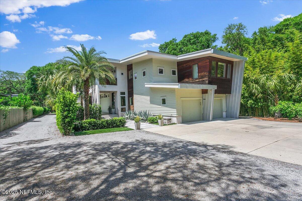 a front view of a house with a garden and yard