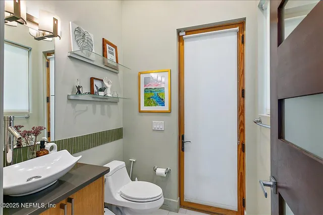 a bathroom with a granite countertop toilet sink and a mirror