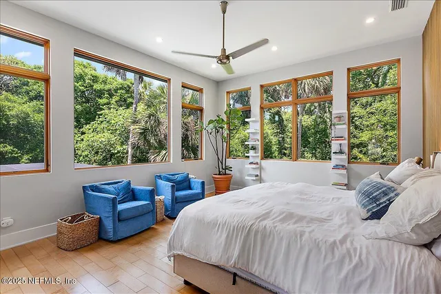 a bedroom with bed and glass windows