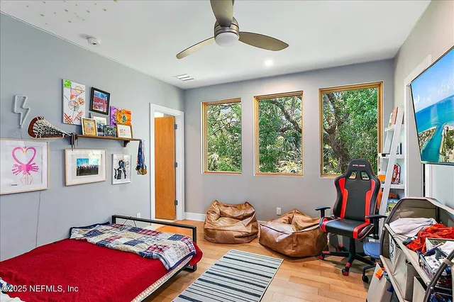 a bedroom with furniture and a large window