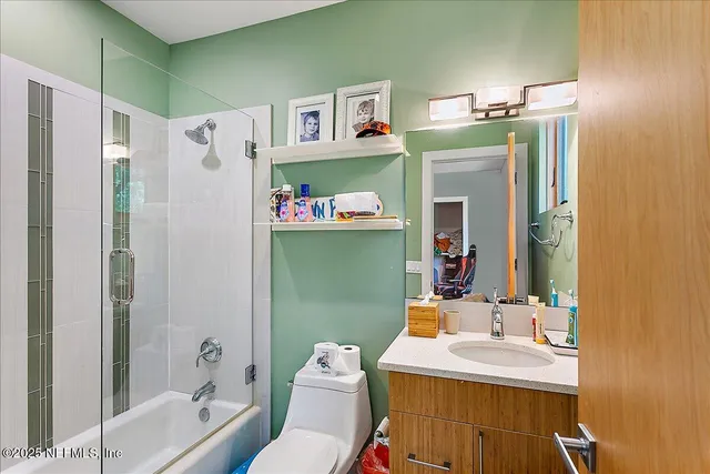 a bathroom with a sink mirror toilet and bathtub