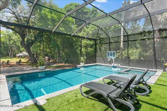 a view of a chair and table in backyard of the house