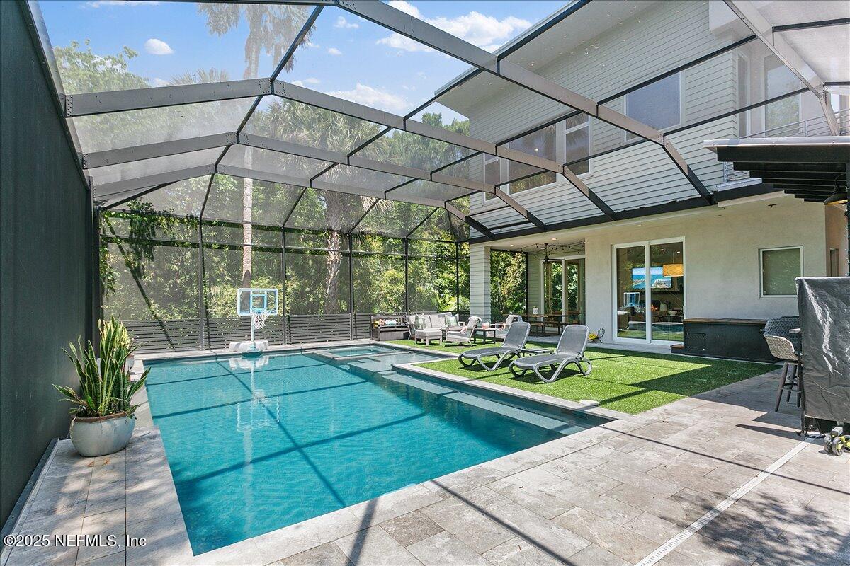 2446 Seminole Road Atlantic Beach, FL 32233 - Photo 29 of 45 a view of a swimming pool with a patio and a yard