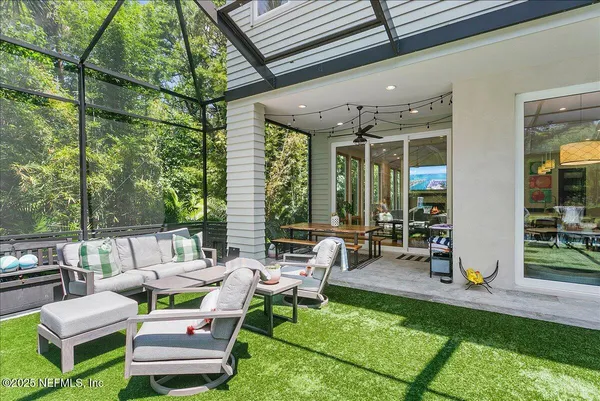 a backyard of a house with table and chairs