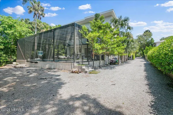 a view of a field with a trees in the background