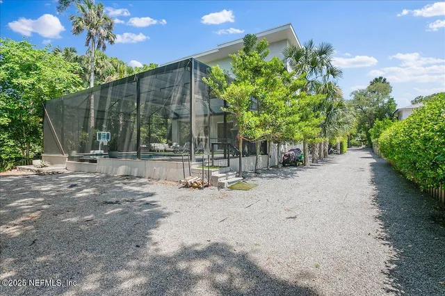 a view of a field with a trees in the background