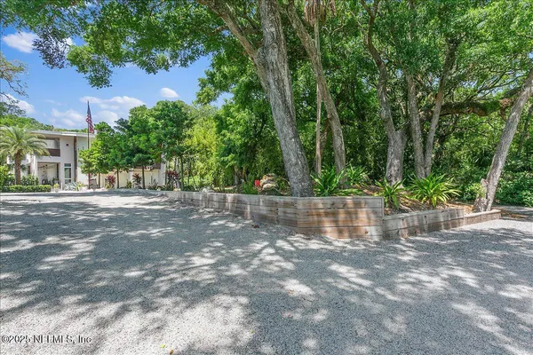 an aerial view of a house with garden space and street view