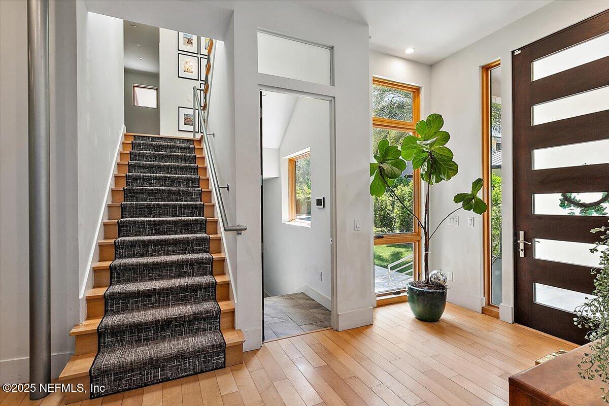 2446 Seminole Road Atlantic Beach, FL 32233 - Photo 4 of 45 a view of an entryway with wooden floor and stairs