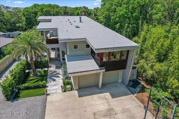 an aerial view of a house with pool