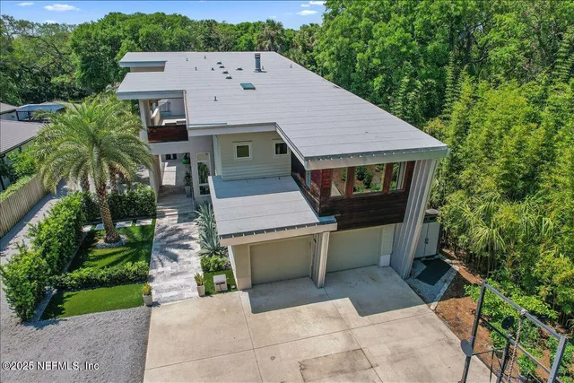 an aerial view of a house with pool