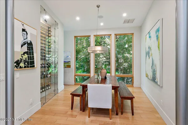 a view of a livingroom with furniture wooden floor and a potted plant