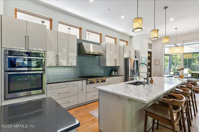 a kitchen with a sink stove and microwave