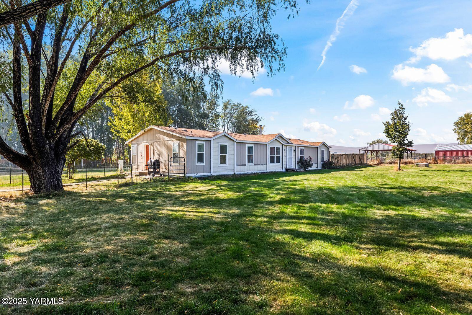 a view of a house with a big yard
