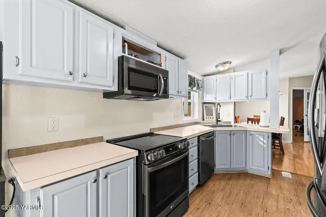 a kitchen with stainless steel appliances a refrigerator and a stove top oven