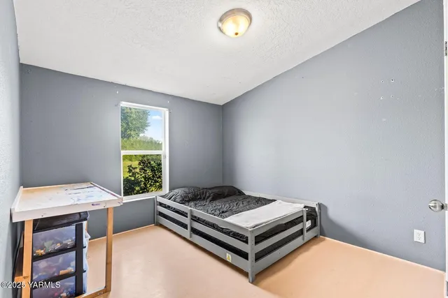 a bedroom with window and stairs