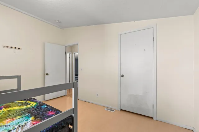 a living room with couches and floor to ceiling window